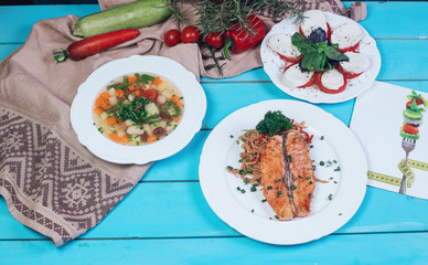 vegetables soup and grill steak fish on the table