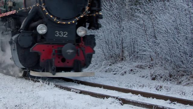 Steam train wheels close-up view in winter forest