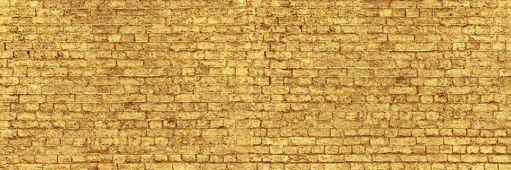 Panoramic Wall of Golden Bricks. Wide Banner for Web With Textured Gilded Surface. Luxury Facade or...