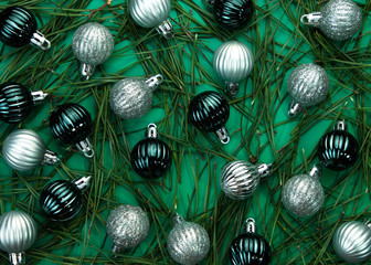 New Year's balls on a minty background with pine needles. Trendy color year. Christmas and New...