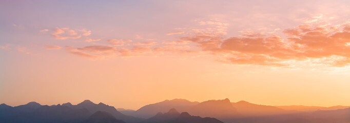 Panoramic mountains view. Beutiful sky and clouds after sunset.  Landscape background.