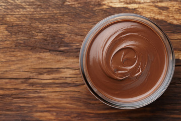 Chocolate spread with on wooden background