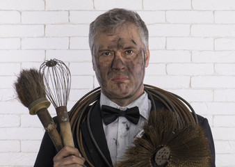 portrait of a chimney sweep in soot, a brush for cleaning chimneys