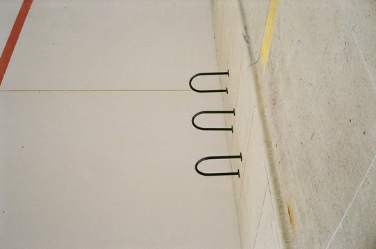 Sidewalk with three black racks