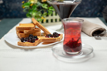 tasty blackberry jam, tea  and toast on the table