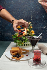 tasty blackberry jam, tea  and toast on the table
