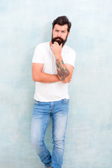 Confident in his choice. Simple and casual summer. Brutal macho gray wall. Male temper brutality....