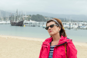 tourist in Baiona, behind the caravel of Colon, Galicia, Spain