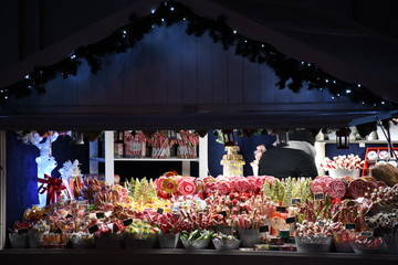 Traditional Christmas market with candies and lollipops , sweets, stall or stand