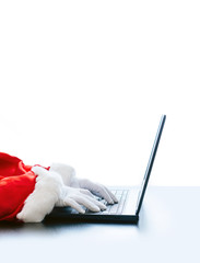 Santa Claus typing computer laptop white hand glove white background red