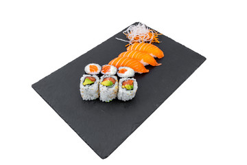 High angle shot of tasty delicious sushi rolls on a black surface