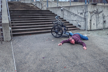Disabled man falling off of wheelchair in accident
