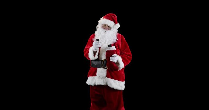 Santa Claus stuffing stocking with coal  on black.
