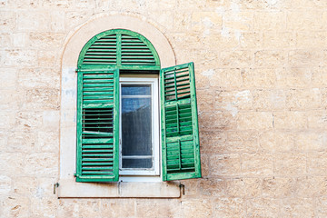 Fototapeta na wymiar vintage background of a window with shutters in an old stone house with copy space