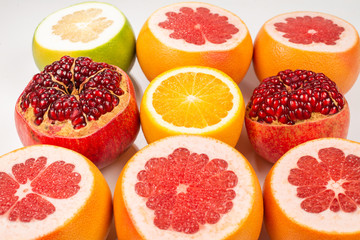 Fototapeta na wymiar Grapefruit, orange, pomegranate, citrus sweetie on white background.