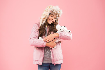 Like my baby. Lovely kid friendly with dog. Shelter for animals. Dalmatian dog. Happy small smiling child play with soft dog on pink background. Little child hold play toy. Kindness concept