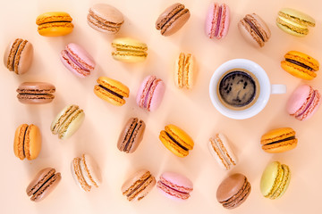 Various colorful macaroons and a cup of coffee