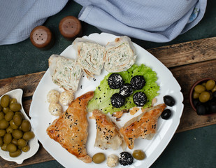 bun with meat, lavash roll and olives  on the table