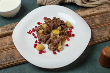National Azerbaijan meal Qovurma, potato,  pomegranate, olives and meat