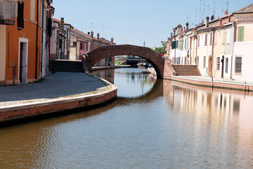 Comacchio , Italy, beautiful town with its narrow streets,  canals and bridges. Houses reflected in...