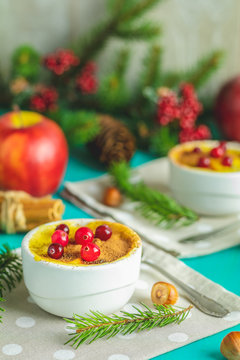 Christmas and New Year composition with sweet delicious apples dessert, spruce branches, cutlery on blue turquoise wooden table surface, copy spice, Holidays background, Christmas table place setting.