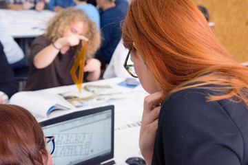 Female redhead Professor Holding Lecture to Multi Ethnic Group of Students. Smart Young People Studying at the University.