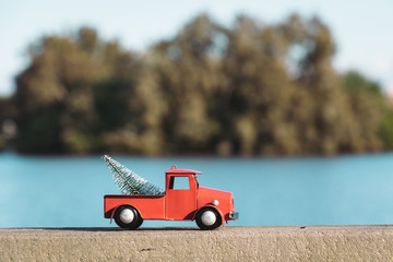 Christmas in Florida concept, red ornament truck drives along dock in  Orlando, Florida.