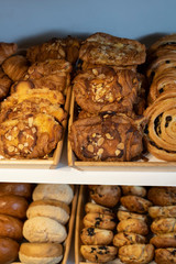Close up freshly baked pastry goods on display in bakery shop