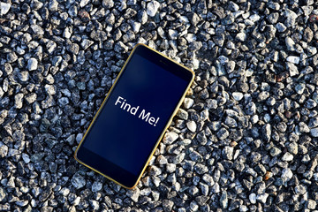 Smartphone on the gravel road. Concept photo: Find Me