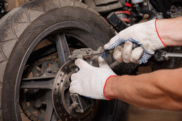 The process of replacing brake pads on a motorcycle.