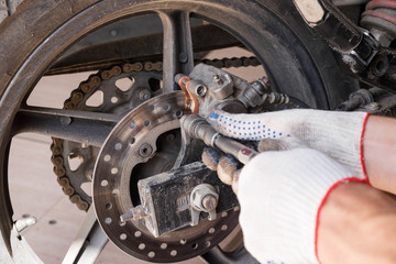 The process of replacing brake pads on a motorcycle.
