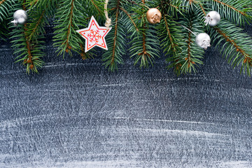 Christmas winter background, Christmas card. Fir branches and holiday decorations on a dark background, top view with space for text.