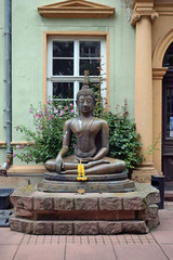 Large Sculpture of Buddha with Flowers in a Public Courtyard 6587-042