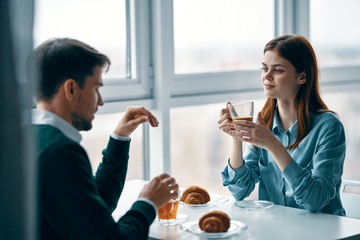 young couple having breakfast in the kitchen