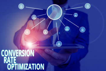 Word writing text Conversion Rate Optimization. Business photo showcasing system for increasing percentage of visitors Male human wear formal work suit presenting presentation using smart device
