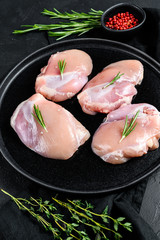 Raw chicken thigh fillet without skin. Farm poultry meat. Black background. Top view