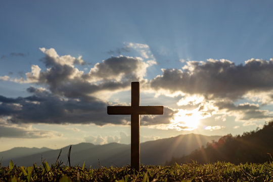 Silhouette cross on mountain at sunset background.Crucifixion Of Jesus Christ - Powered by Adobe