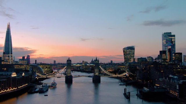 Aerial view of City of London Skyline, The Shard, Tower Bridge and Thames River at dusk in London