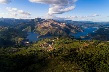 Aerial panoramic view of the historic village of Lindoso, with the surroundings mountains and lake, at the Peneda Geres National Park, in Portugal.