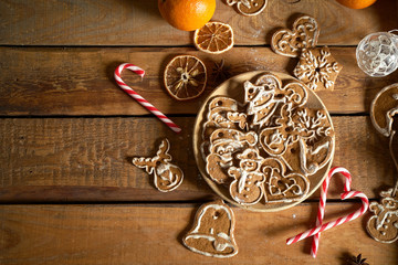 Christmas gingerbread on wooden plate on kitchen old table