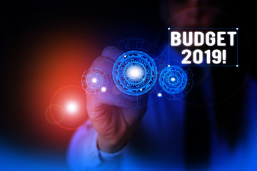 Text sign showing Budget 2019. Business photo showcasing estimate of income and expenditure for current year Woman wear formal work suit presenting presentation using smart device