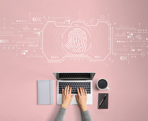 Fingerprint scanning theme with person using a laptop
