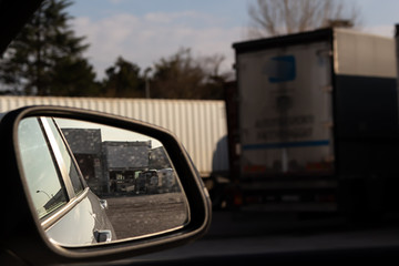 industrial building reflected in the car mirror