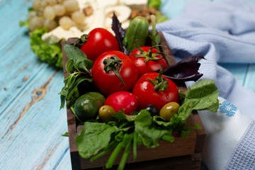 tomato, cucumber, basil, olives on the table