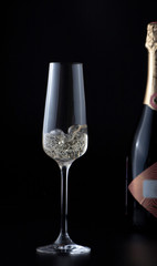 Glass with sparkling champagne at black background, magazine and commercial photo with space for text or design, festive and celebrating food and drink photography