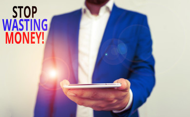 Word writing text Stop Wasting Money. Business photo showcasing advicing demonstrating or group to start saving and use it wisely Business concept with man holding mobile phone with touch screen