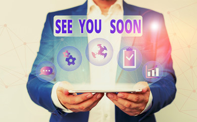 Word writing text See You Soon. Business photo showcasing used for saying goodbye to someone and going to meet again soon Male human wear formal work suit presenting presentation using smart device