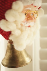 Portrait Santa Claus face in glasses and red hat with bell.