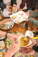 Volunteers giving food to homeless people, top view