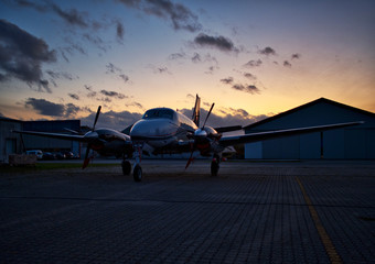 Fototapeta na wymiar Propeller aircraft in sunset at aerodrome
